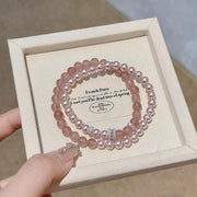 Two-piece dusty pink pearl bracelet set displayed in a box