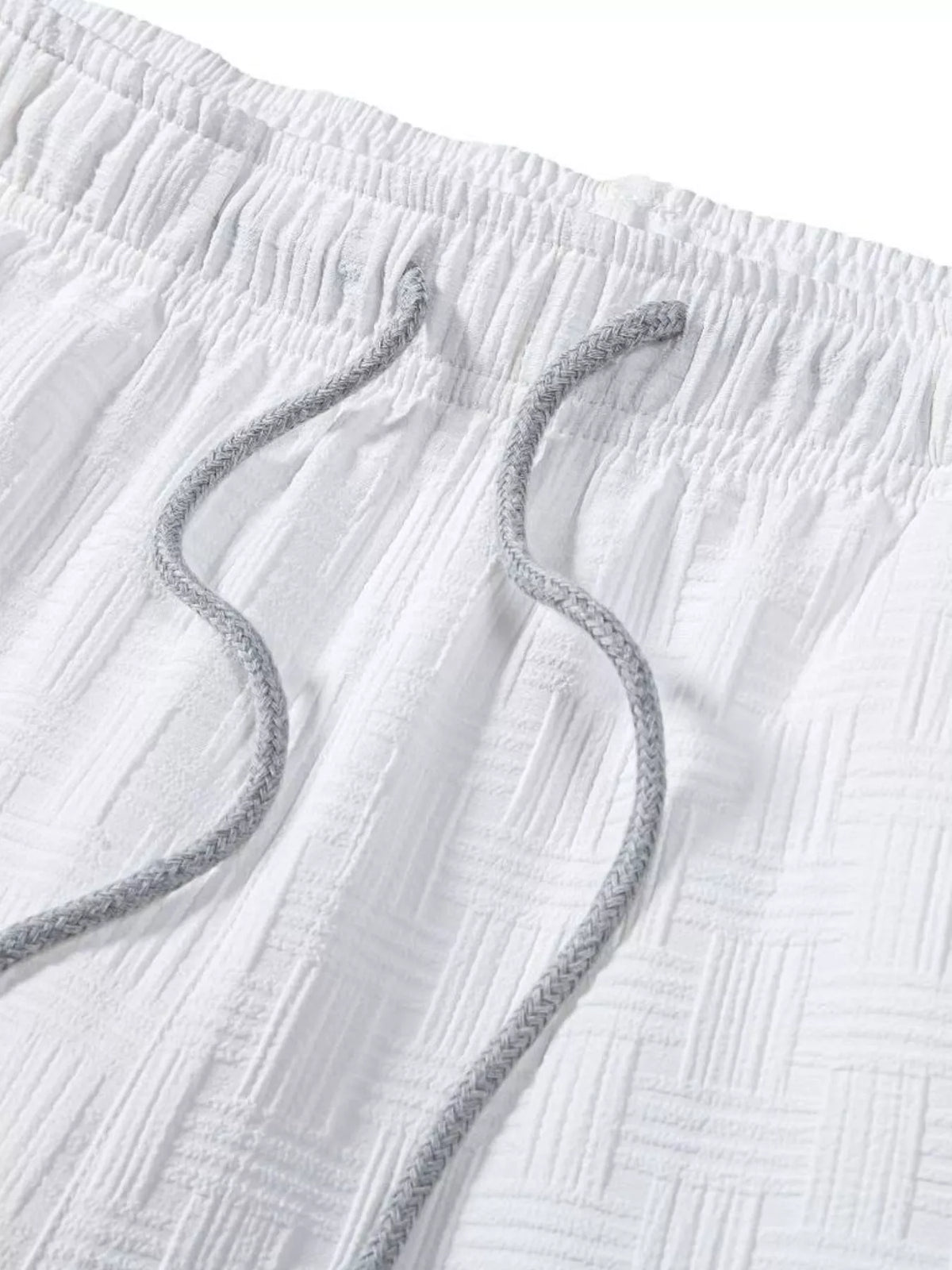 Close-up of white shorts' elastic waistband and drawstring