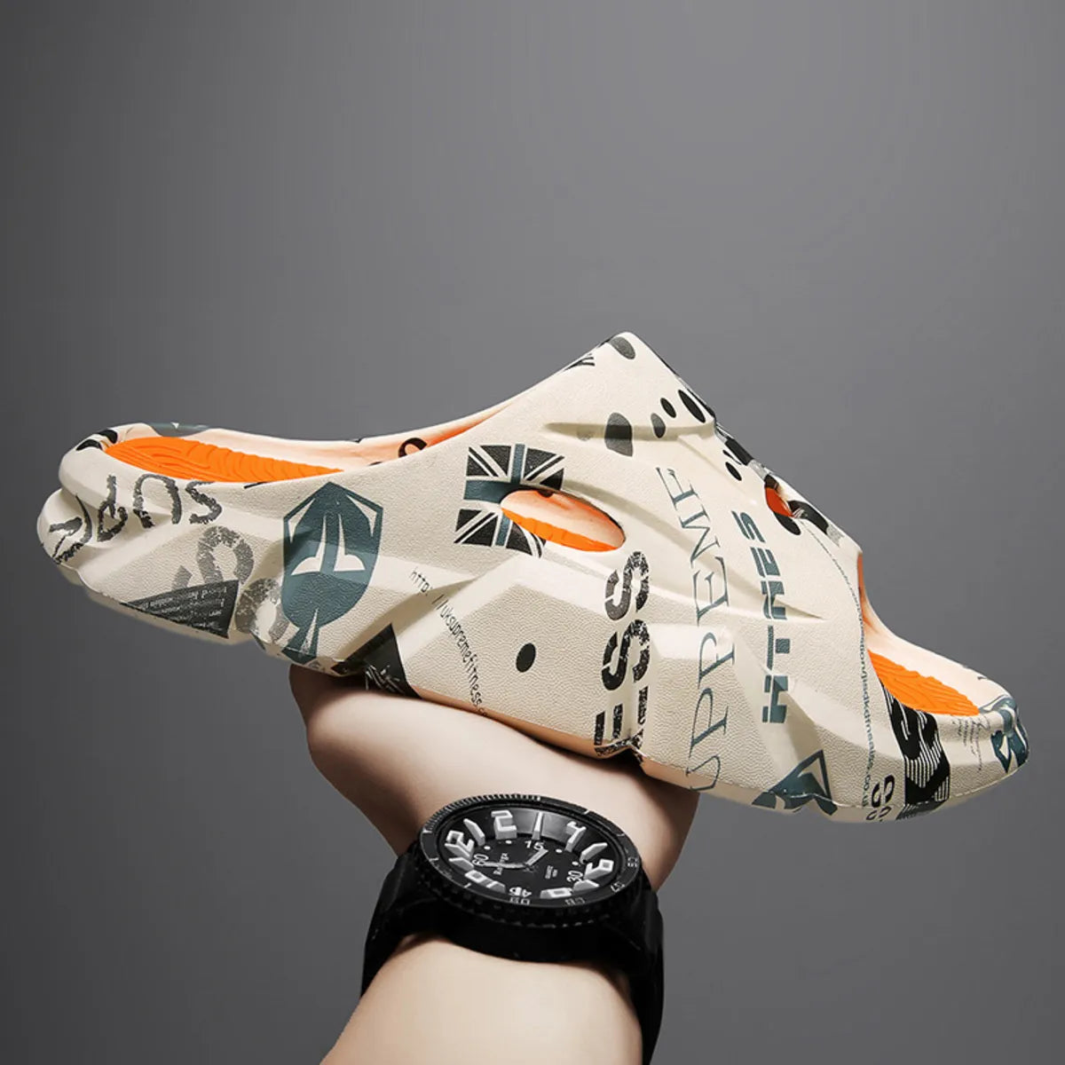 Beige graphic-print platform slide with orange footbed and open toe, held in profile