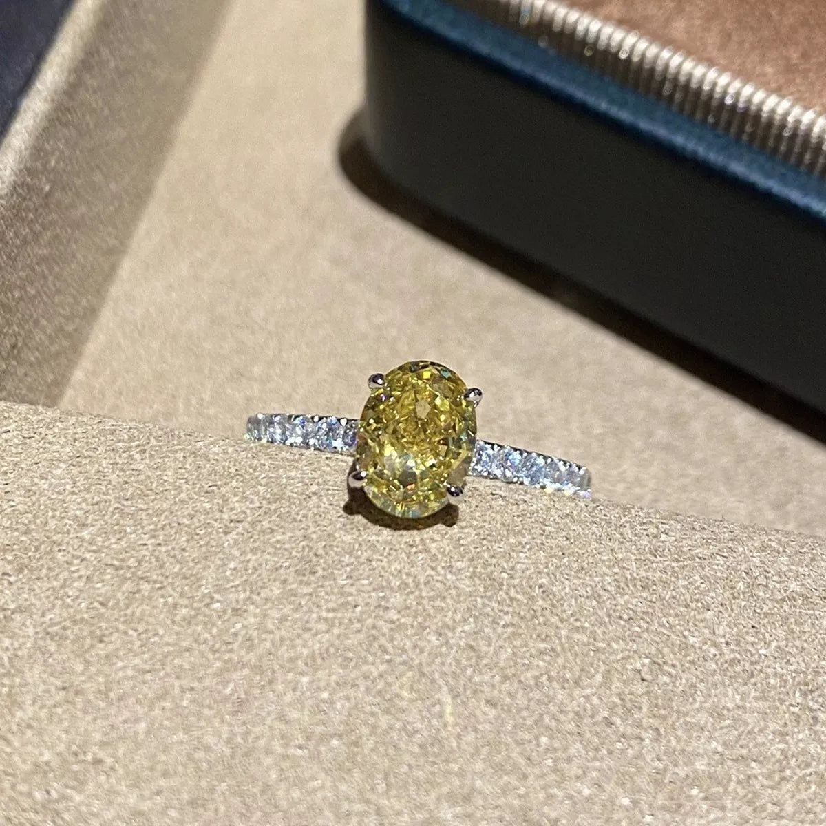 Copper oval zircon ring with polished yellow finish, close-up