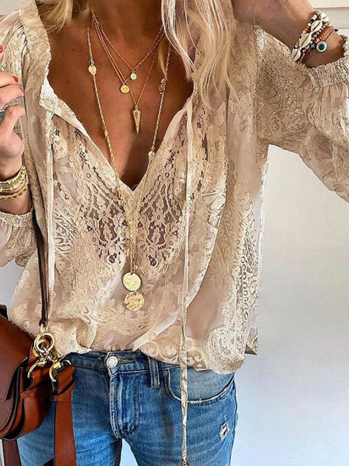 Close view of khaki blouse's floral lace, V-neck and tie-front