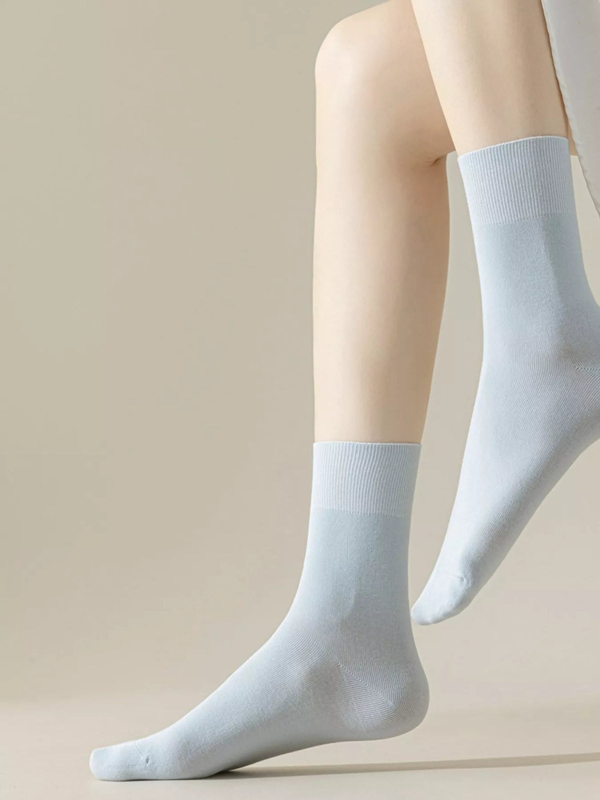 Light blue solid crew socks worn with shoes