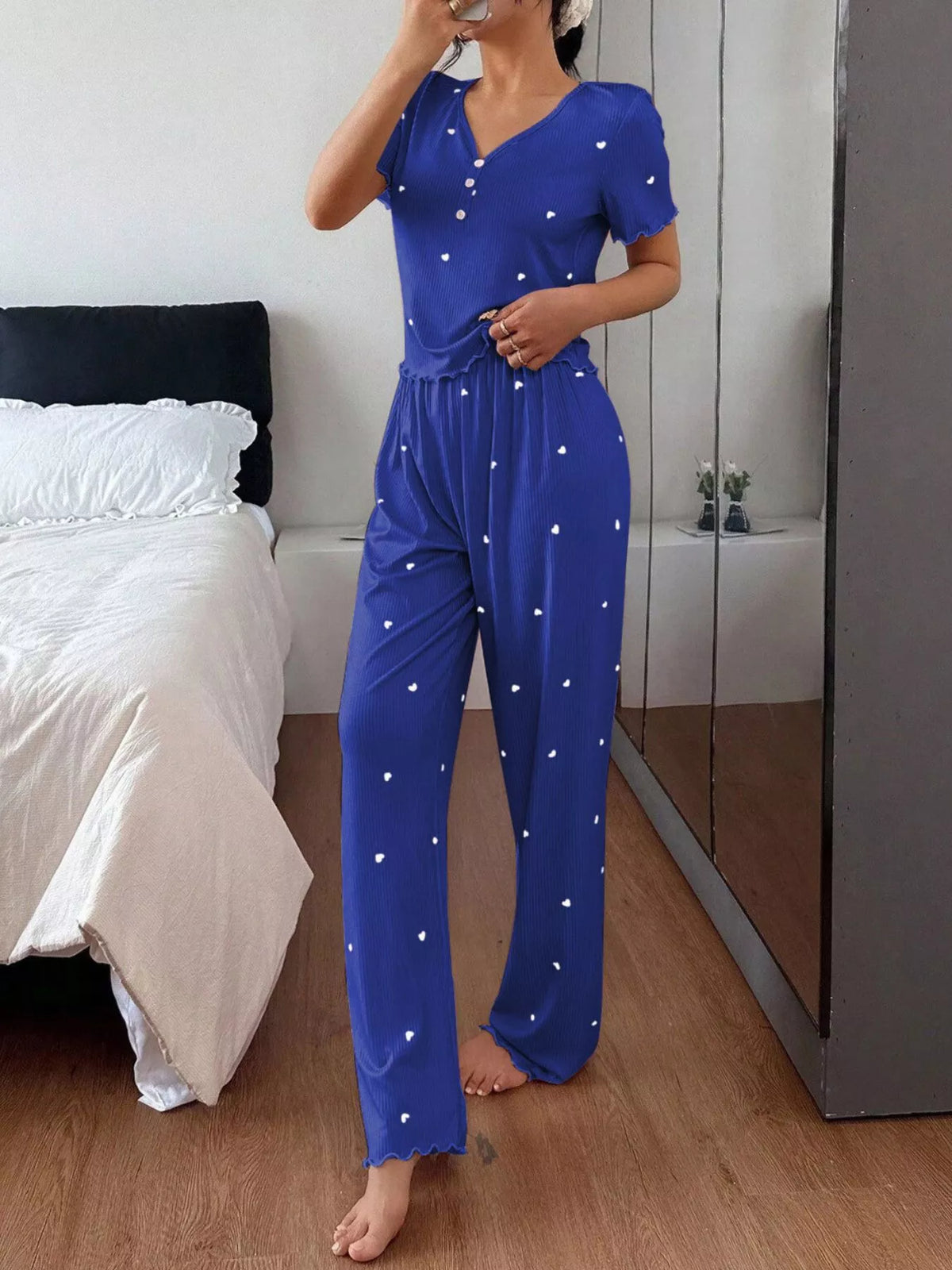 Model wearing blue heart-print loungewear set with lettuce-trim hems