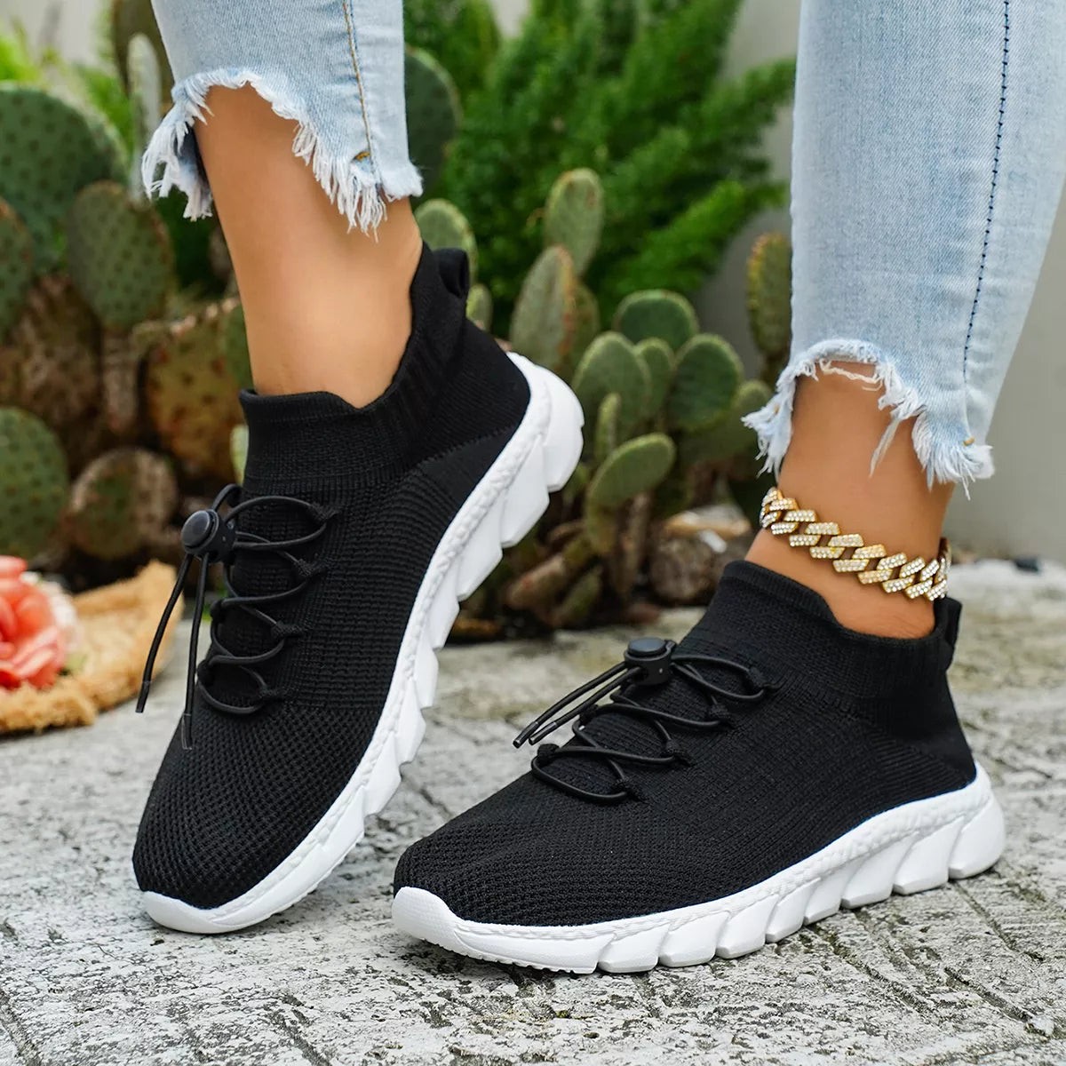 Black knit lace-up sneakers with thick white soles
