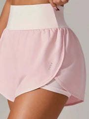 Side view of pale pink wrap-front shorts over fitted inner shorts