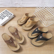 Black, taupe and tan toe-post wedge sandals with perforated straps displayed together