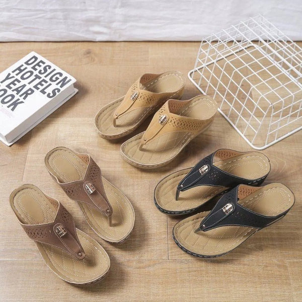 Black, taupe and tan toe-post wedge sandals with perforated straps displayed together