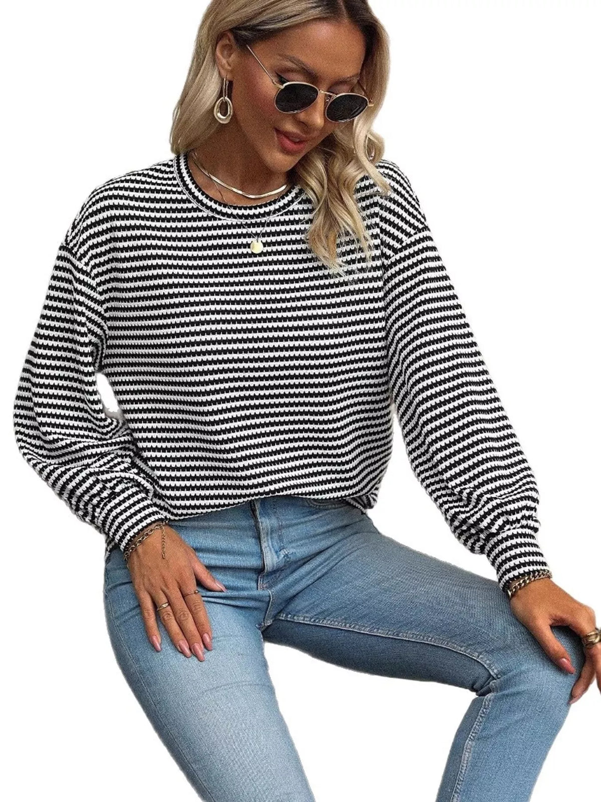 Model wearing black-and-white striped lantern-sleeve top