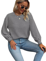 Model wearing black-and-white striped lantern-sleeve top