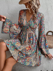 Model wearing paisley print dress with flared skirt, front view