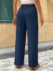 Close-up of navy pants with flower-shaped embroidery