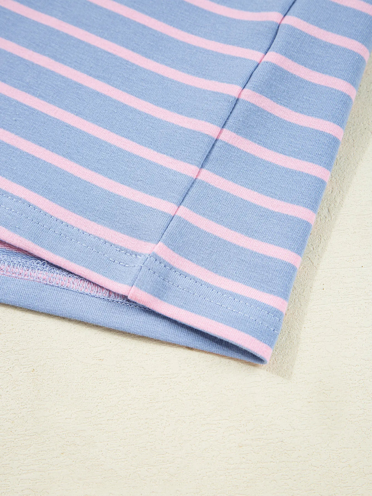 Pink cuff and sleeve seam on striped top