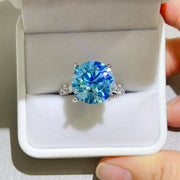 Blue-green centre-stone ring displayed inside a white jewellery box