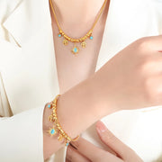 Close detail of blue stones and dangling gold charms