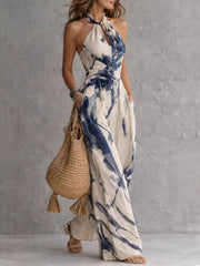 Angled full-length view of the blue ink-wash jumpsuit with a hand in a pocket.