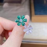 Close-up of the green jeweled flower and clear flower accents on the ring