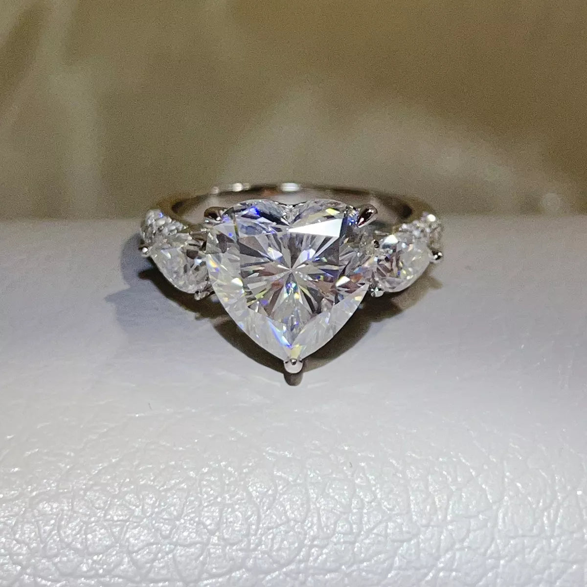 Clear heart-shaped moissanite ring shown from the front.