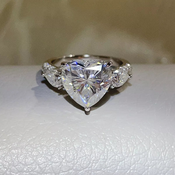 Clear heart-shaped moissanite ring shown from the front.