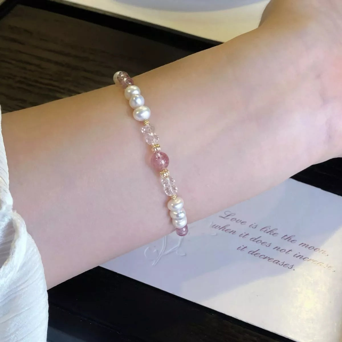 Close-up of the pearl and crystal bracelet on a wrist