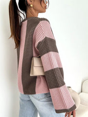 Side view of pink and brown colour-block sweater showing striped sleeve