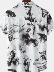 Back of a white short-sleeve shirt with black ink-splash print