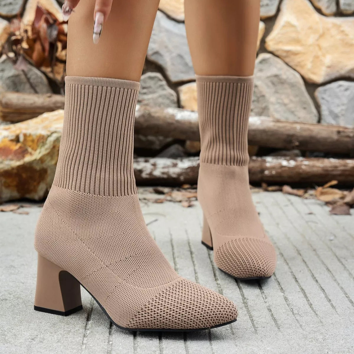 Front view of a pair of taupe ribbed knit sock boots with block heels