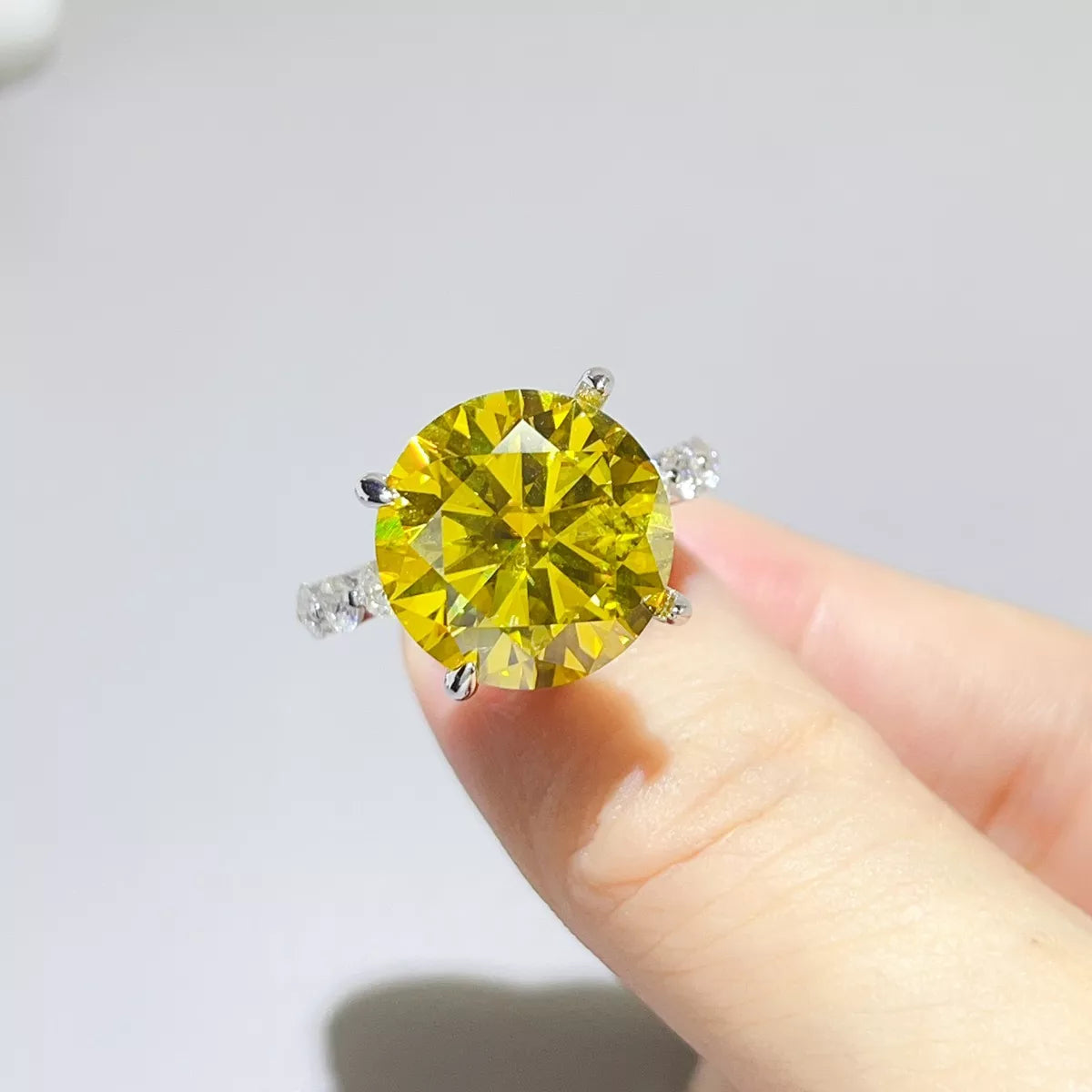 Close-up of yellow centre-stone ring held between fingers