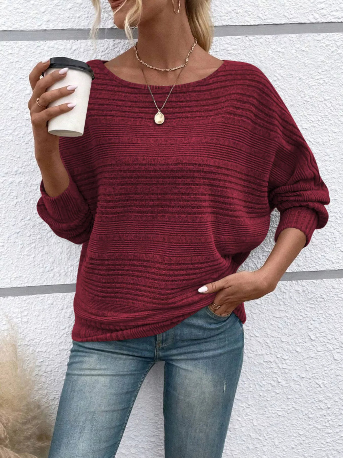 Women’s ribbed round-neck long-sleeve top in burgundy front view holding cup
