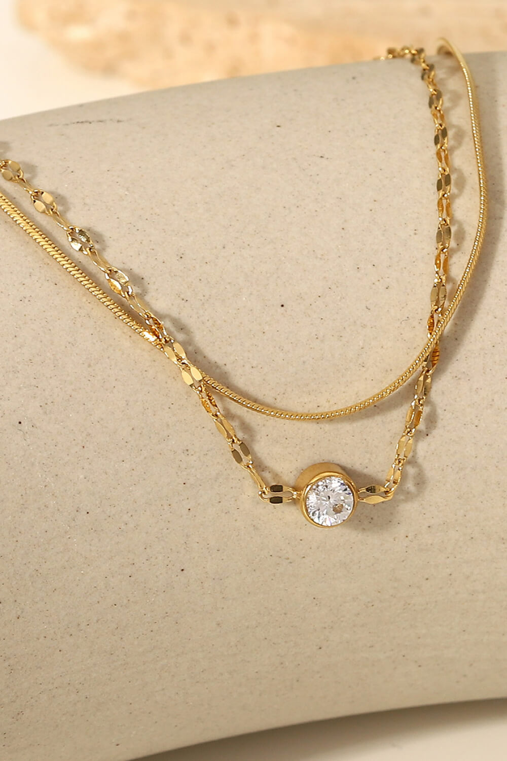 Detail of the layered bracelet clasp and extension chain
