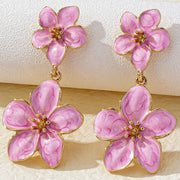Pale pink double-flower drop earrings with gold-tone centers and connecting links.