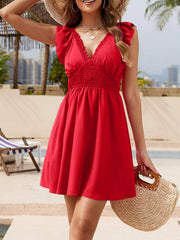Front view of red ruffled V-neck mini dress on model