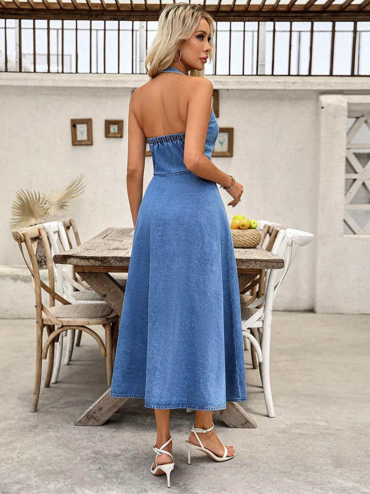 Back view of blue halter-neck denim maxi dress