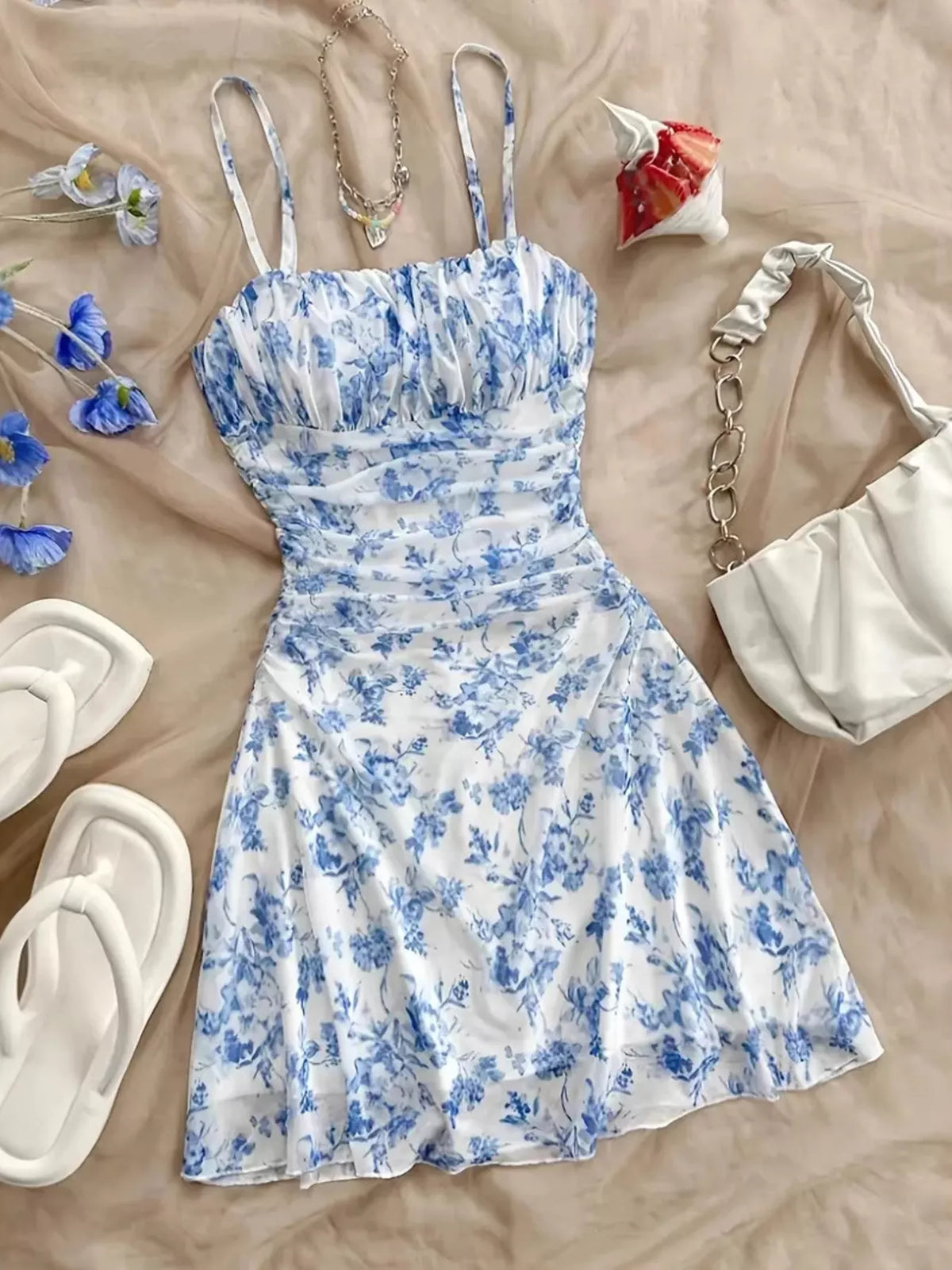 Blue floral spaghetti-strap mini dress laid flat, front view