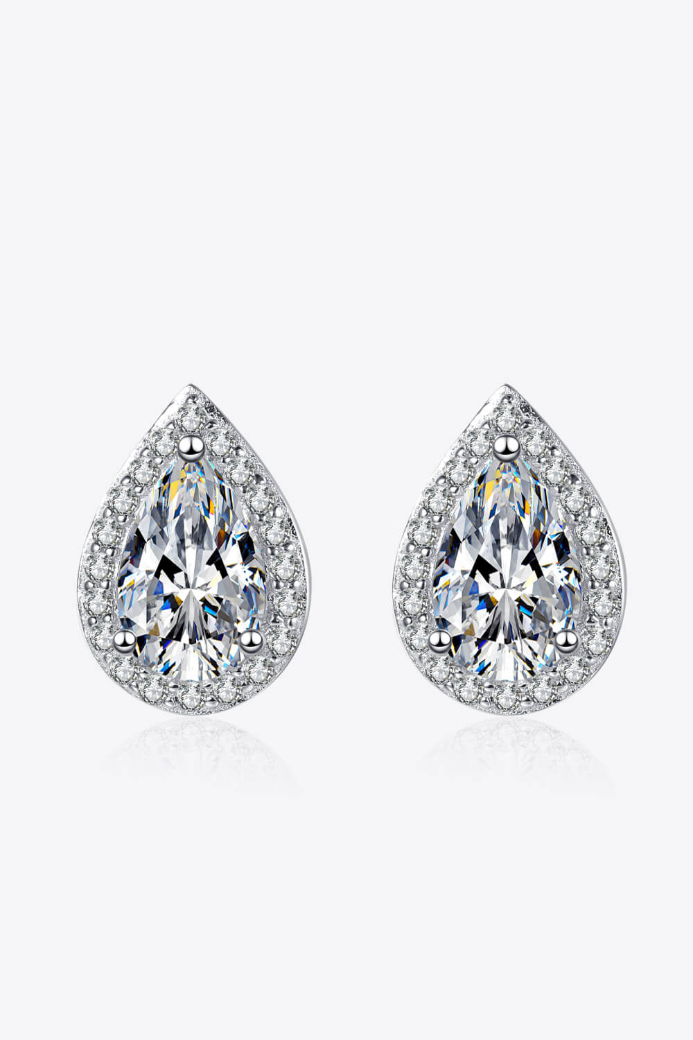 Pair of teardrop-shaped clear stone stud earrings in silver-tone halo settings