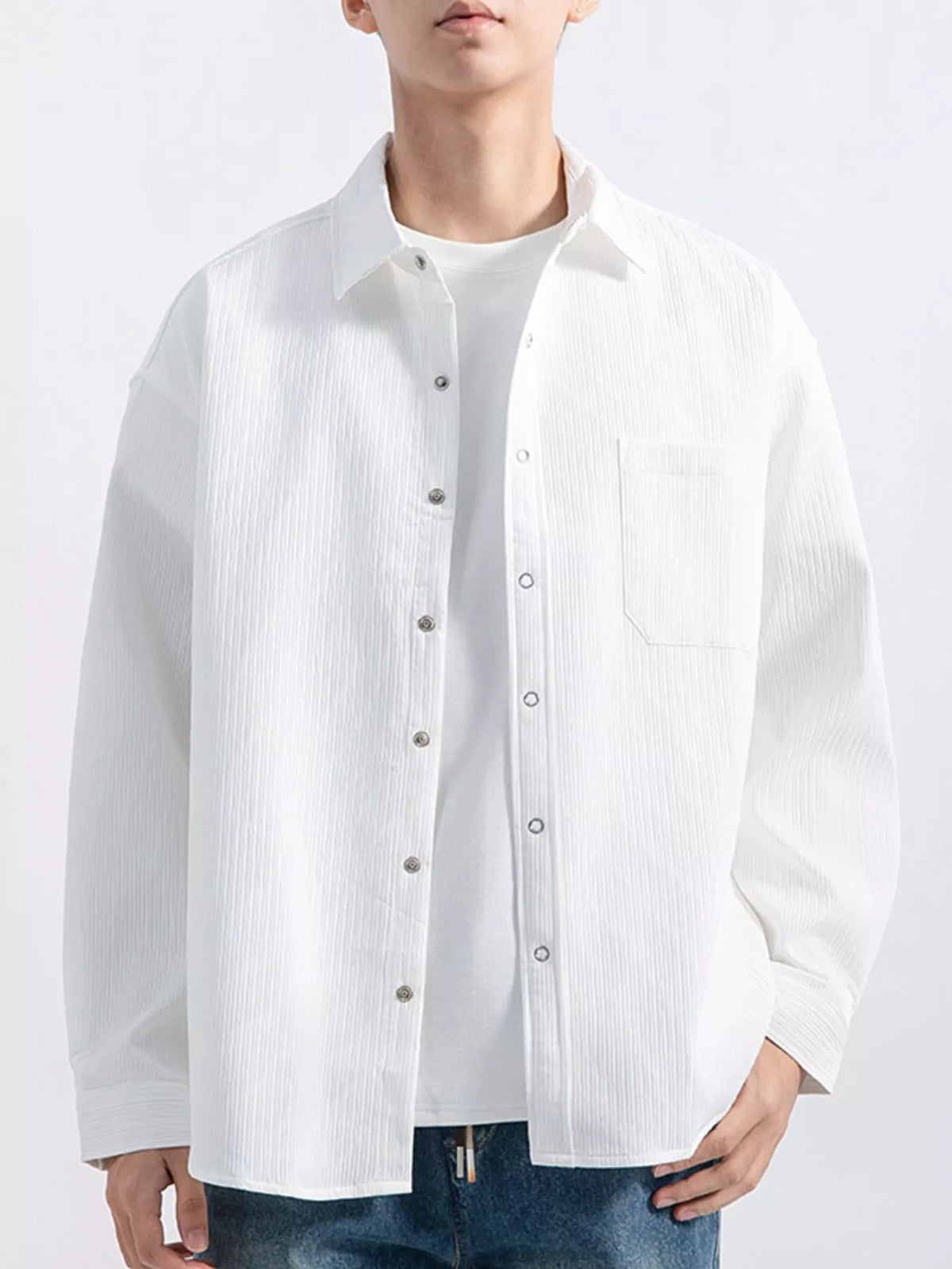 White textured button-down shirt layered over a white tee