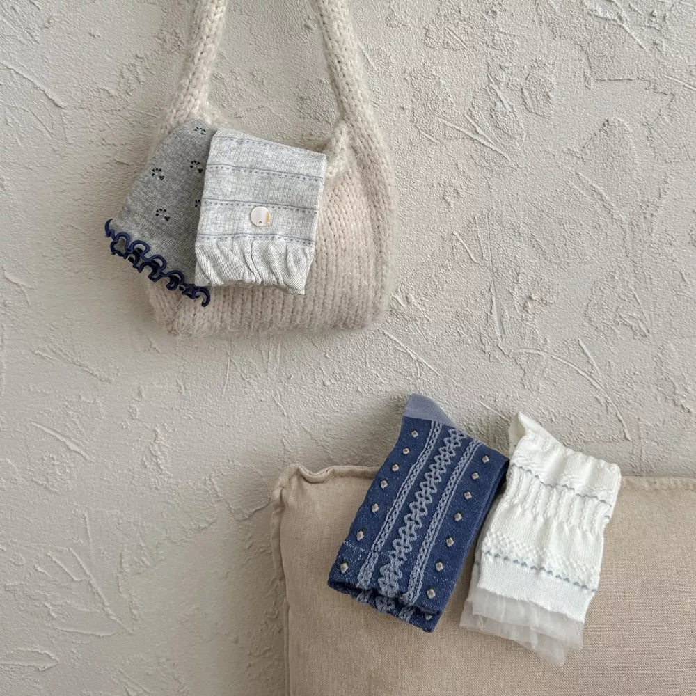 Blue and white knit socks folded in a tote bag