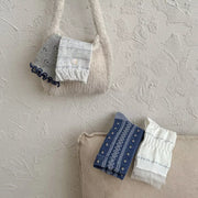 Blue and white knit socks folded in a tote bag
