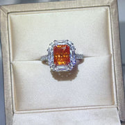 Front view of orange center stone ring in presentation box