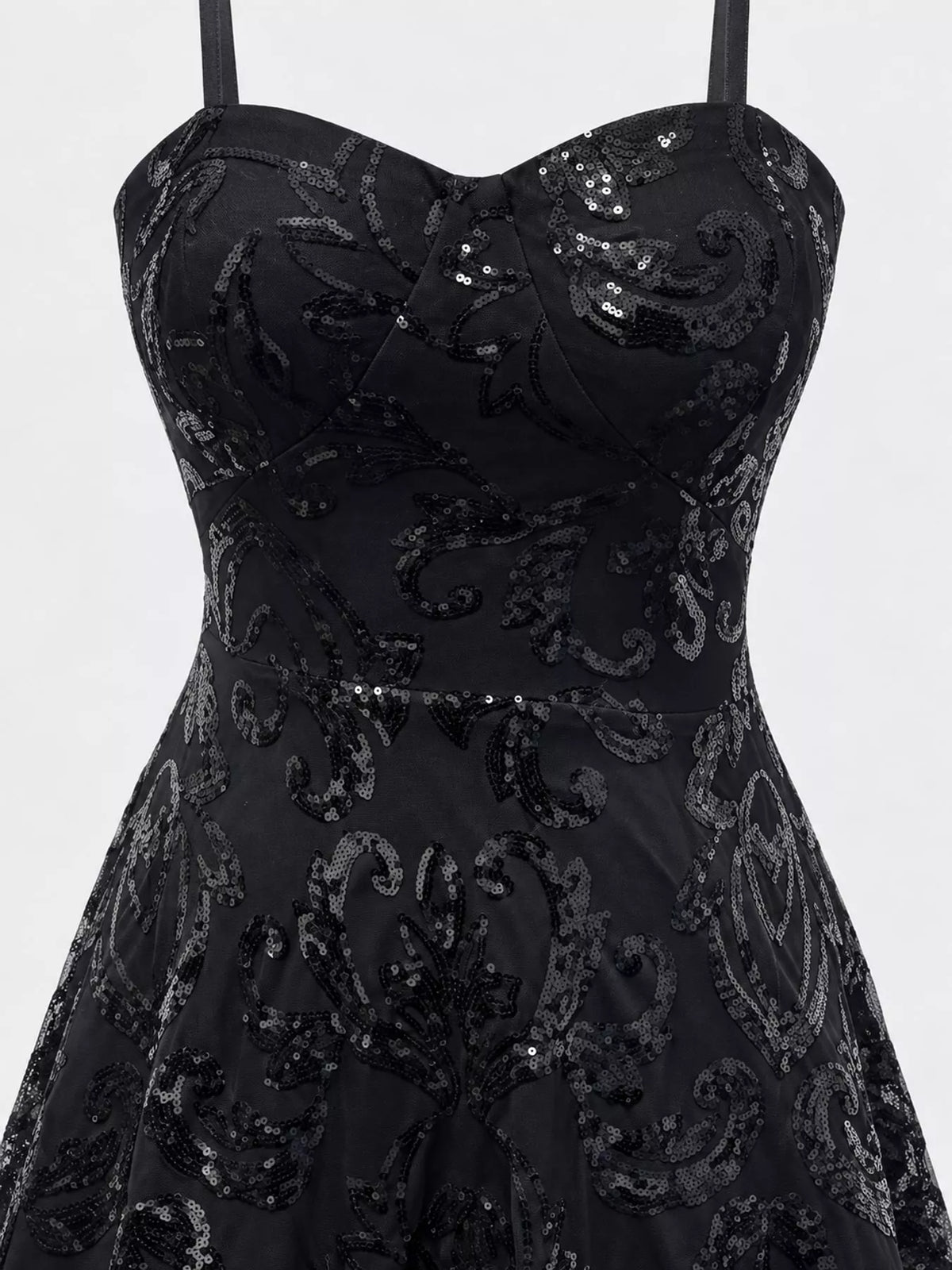 Close-up of the black dress's sweetheart bodice, floral sequins and waist seam.