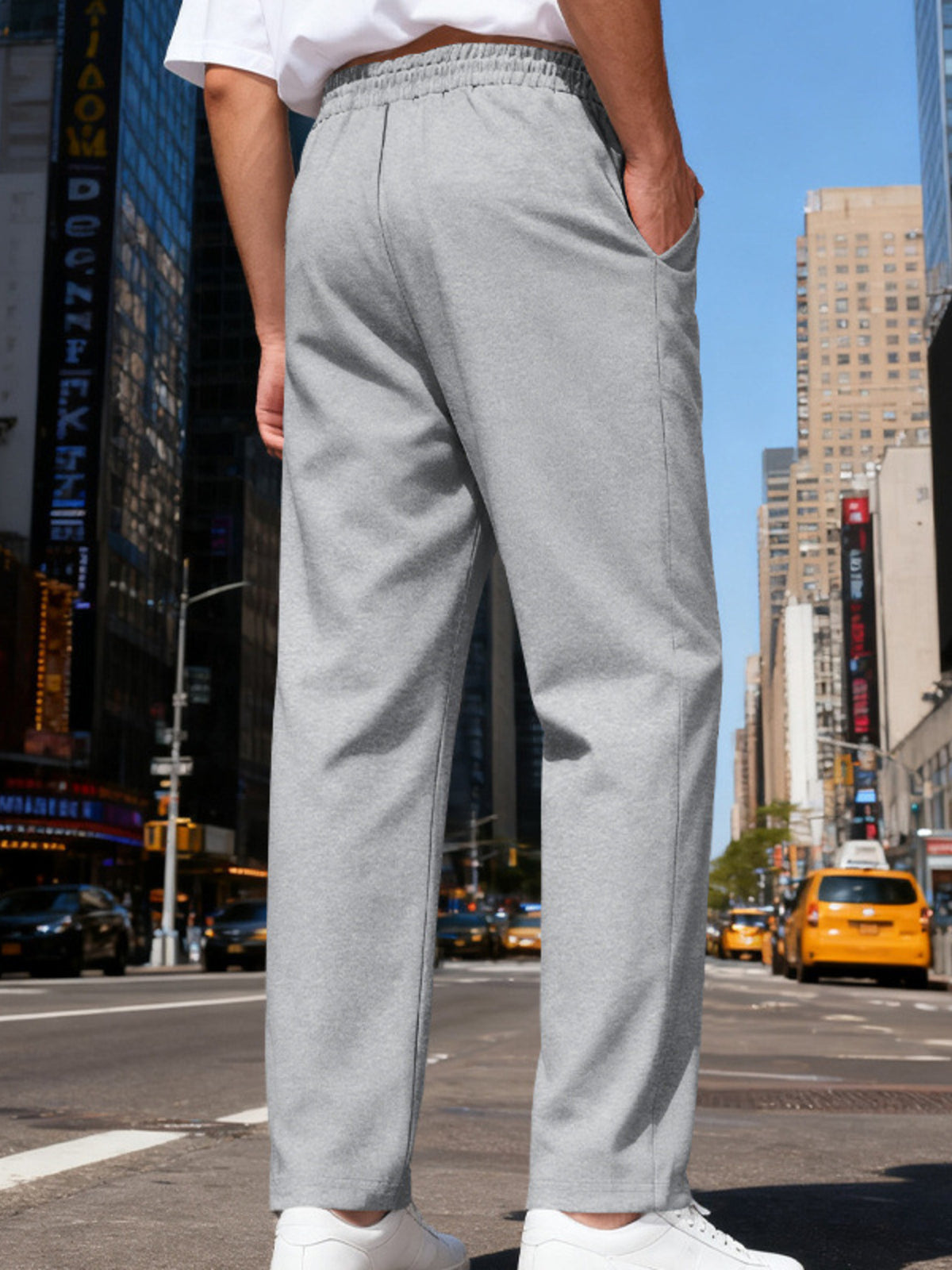 Side view of white pants styled with a light overshirt.