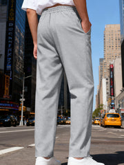 Side view of white pants styled with a light overshirt.