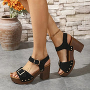 Black studded two-buckle platform sandals with brown soles and block heels, front view