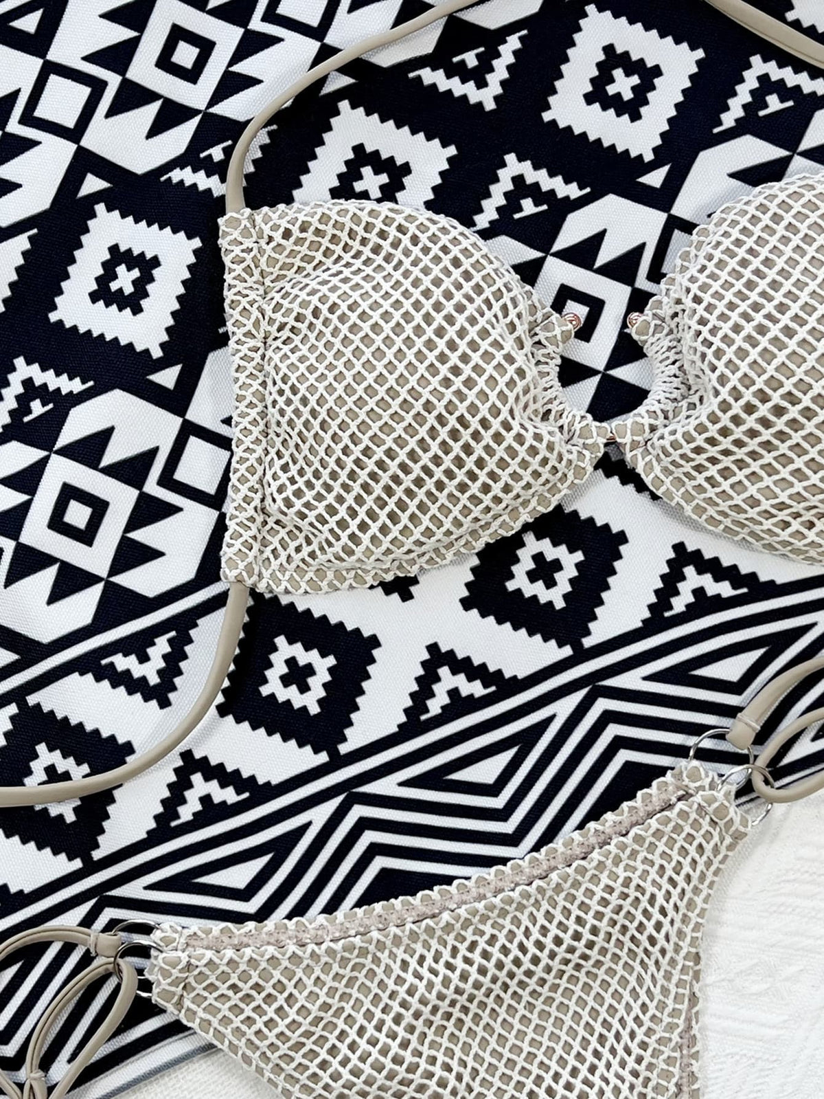 Close-up of cream fishnet bikini cups and matching mesh bottoms