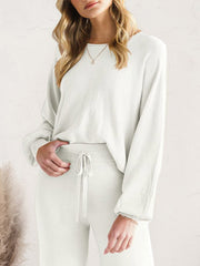White wide-leg lounge pants shown from the waist down