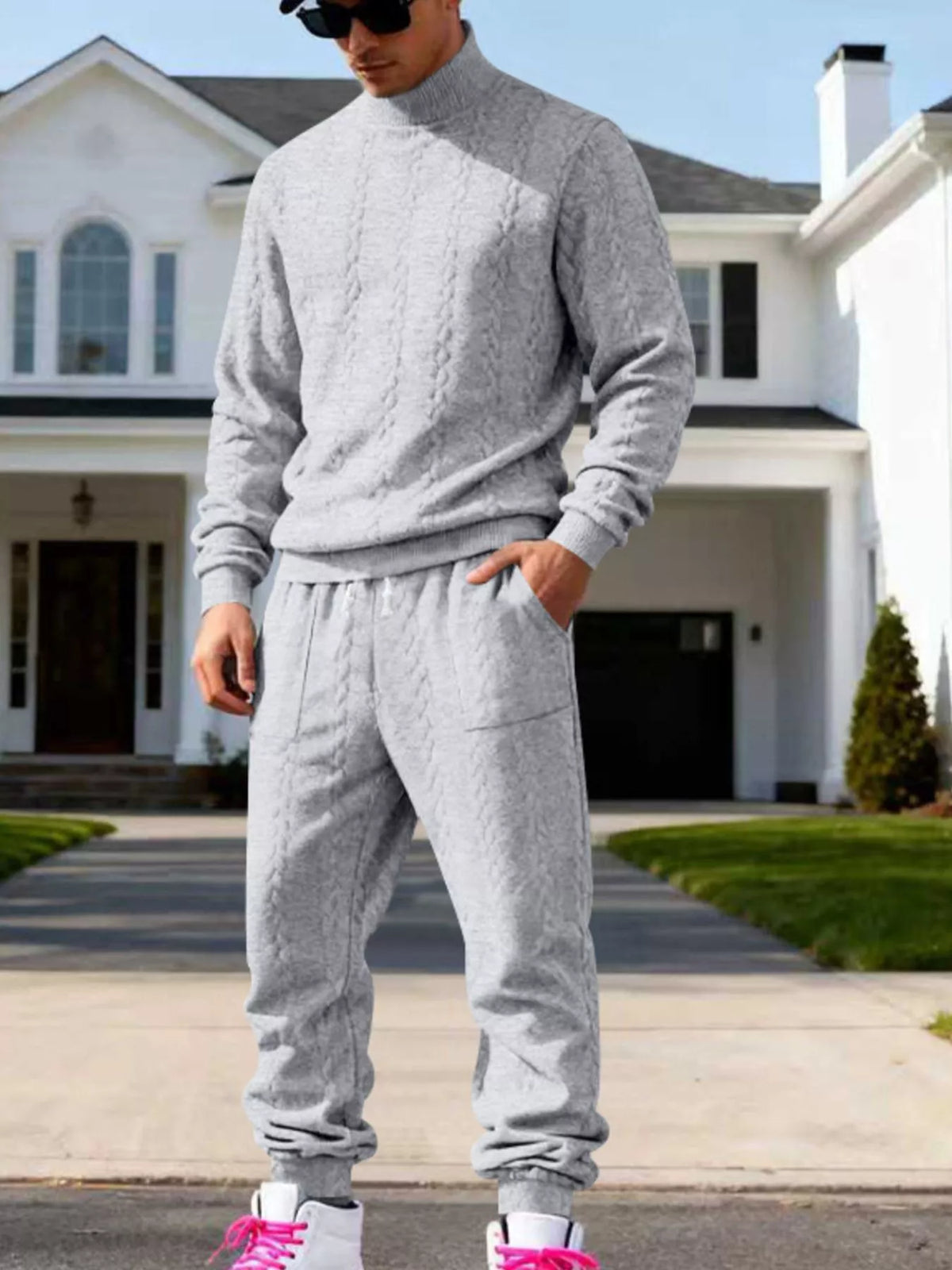 Light gray cable-knit mock-neck sweater and joggers worn front-facing.