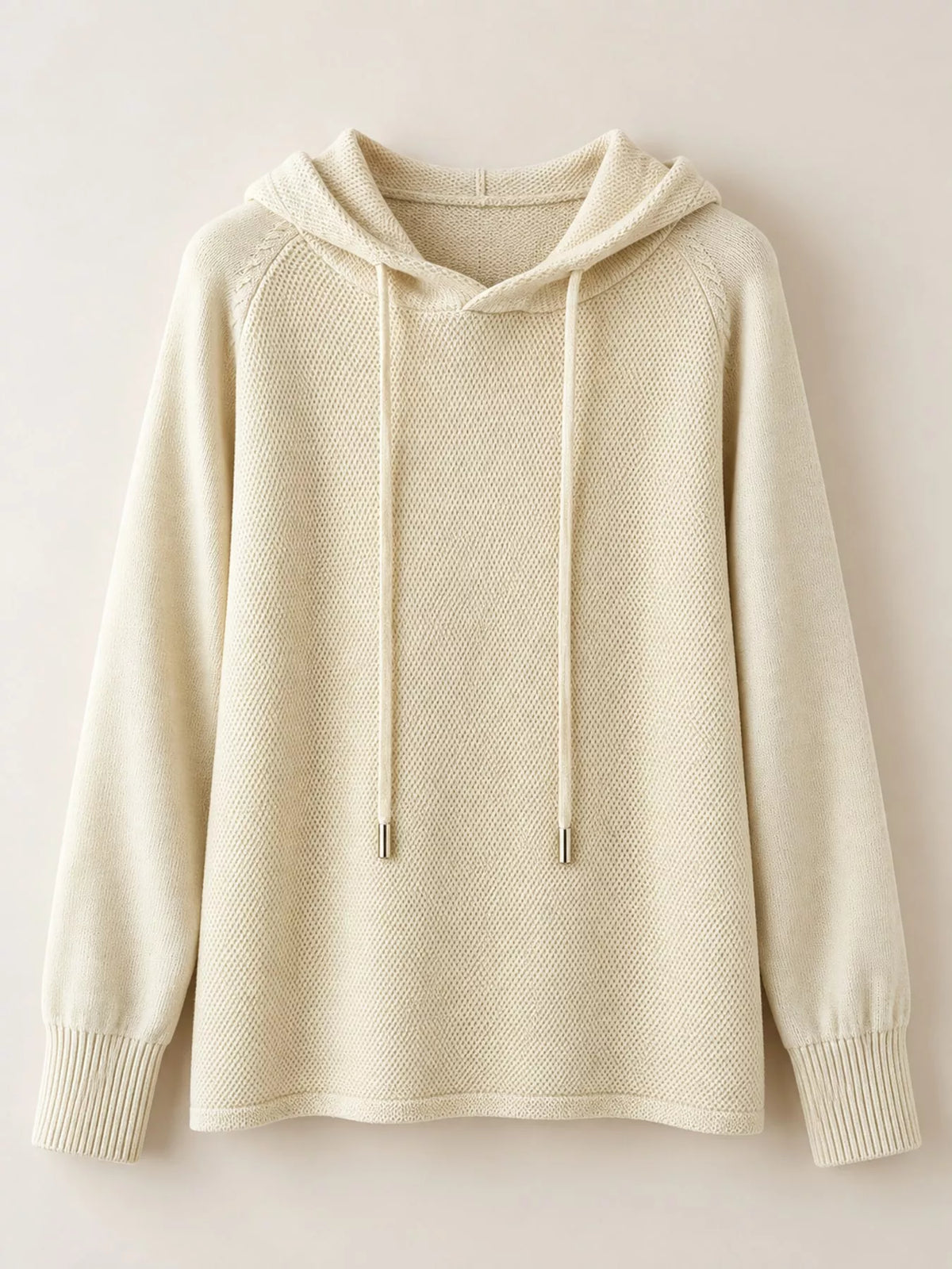Cream drawstring hooded sweater displayed alone against a pale background.