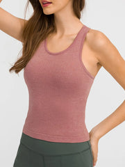 Model wearing a dusty rose ribbed racerback tank, front view
