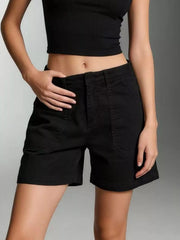 Black denim shorts with large front patch pockets and stitched hems, worn with a black crop top