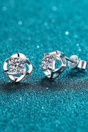 Clear-stone stud earrings on teal showing a front setting and rear post