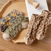 Grey yellow-flower, green spiral and brown floral ankle socks arranged together